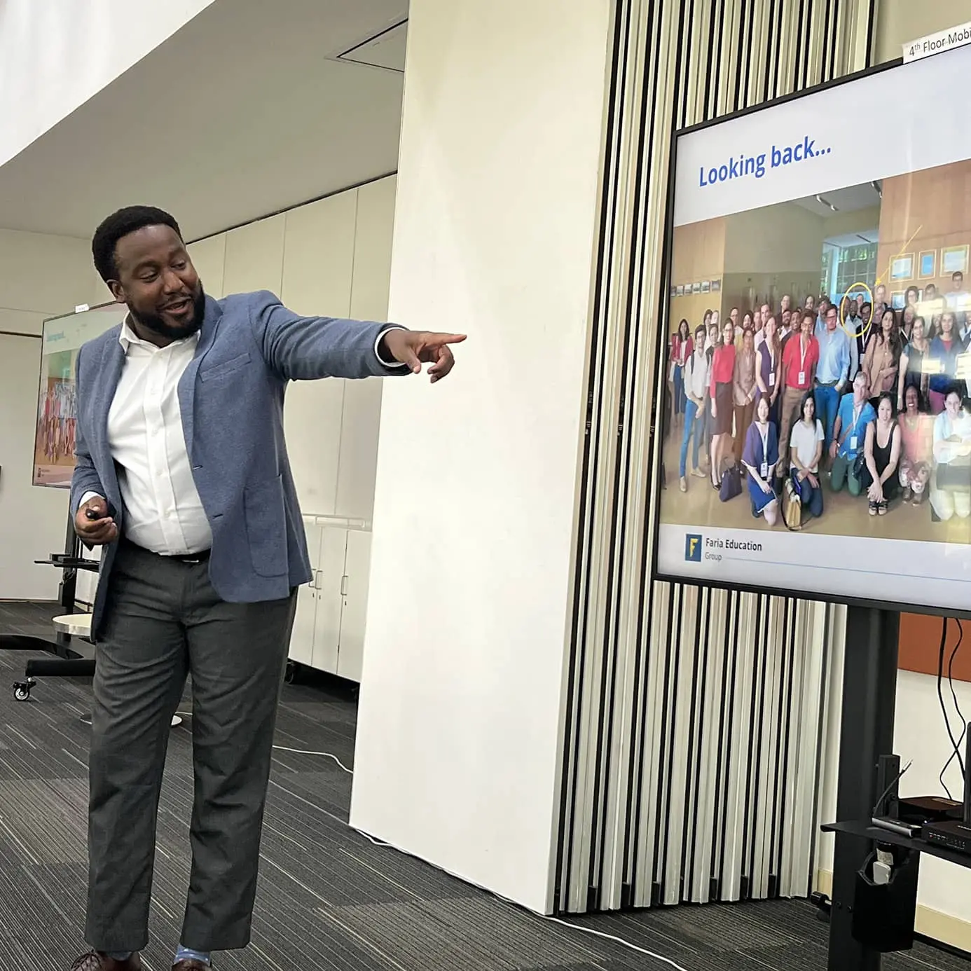 Faria employee pointing at presentation screen