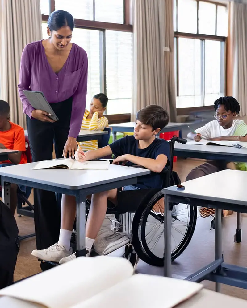 A teacher with a boy in a wheelchair
