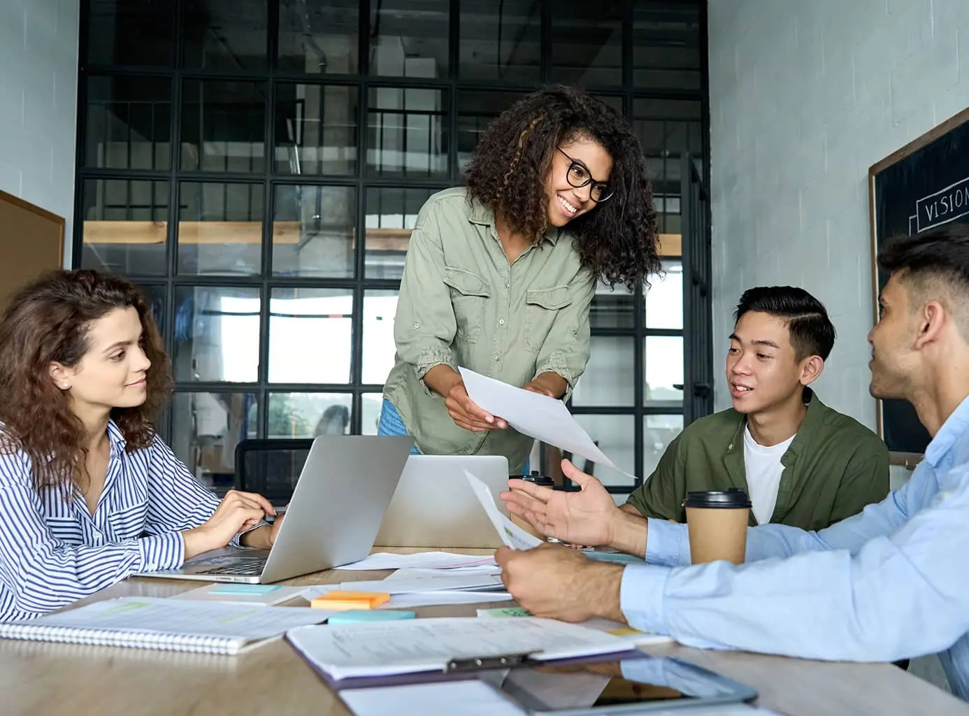Two men and two women working through documents together